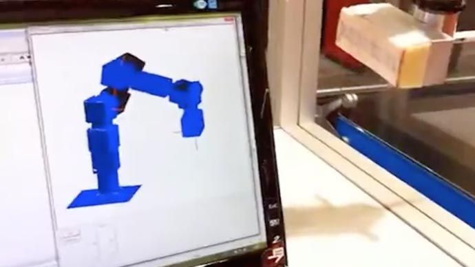 Watch An Industrial Robot, programmed with MATLAB and Simulink writes a surprise message on a glass panel.