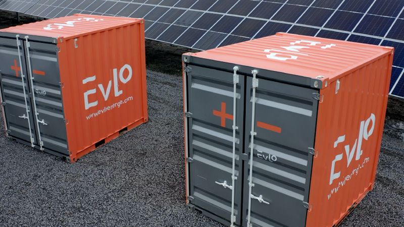 Two EVLO 500s, orange metal boxes with a silver front with a plus sign on the left and minus sign on the right.