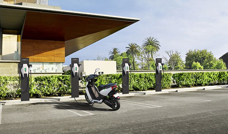 The Ather 450 scooter is charging at one of four charging spaces.
